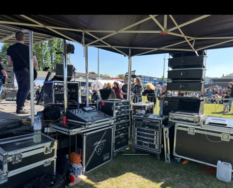 Pa system for live events Sound equipment and speaker stacks set up under a tent at a live outdoor event.